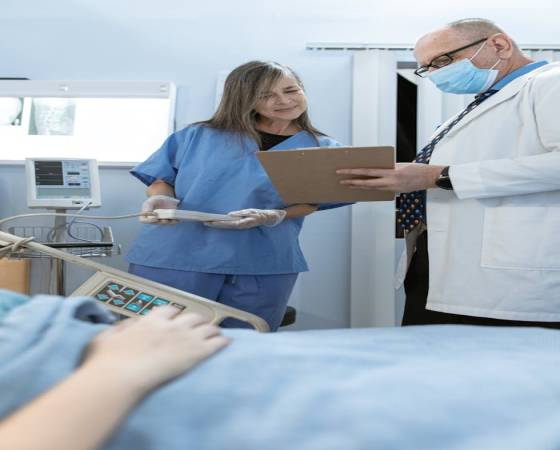 Home Doctor and nurse discussing patient care in a hospital setting